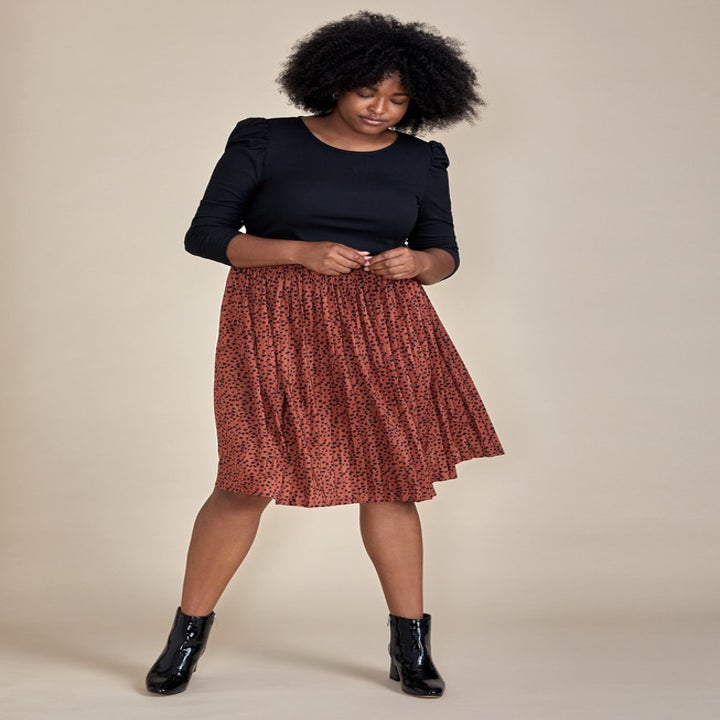 model wearing the skirt in a spotted print 