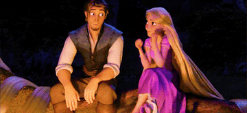 Rapunzel putting her chin in her hands next to Flynn by the fire