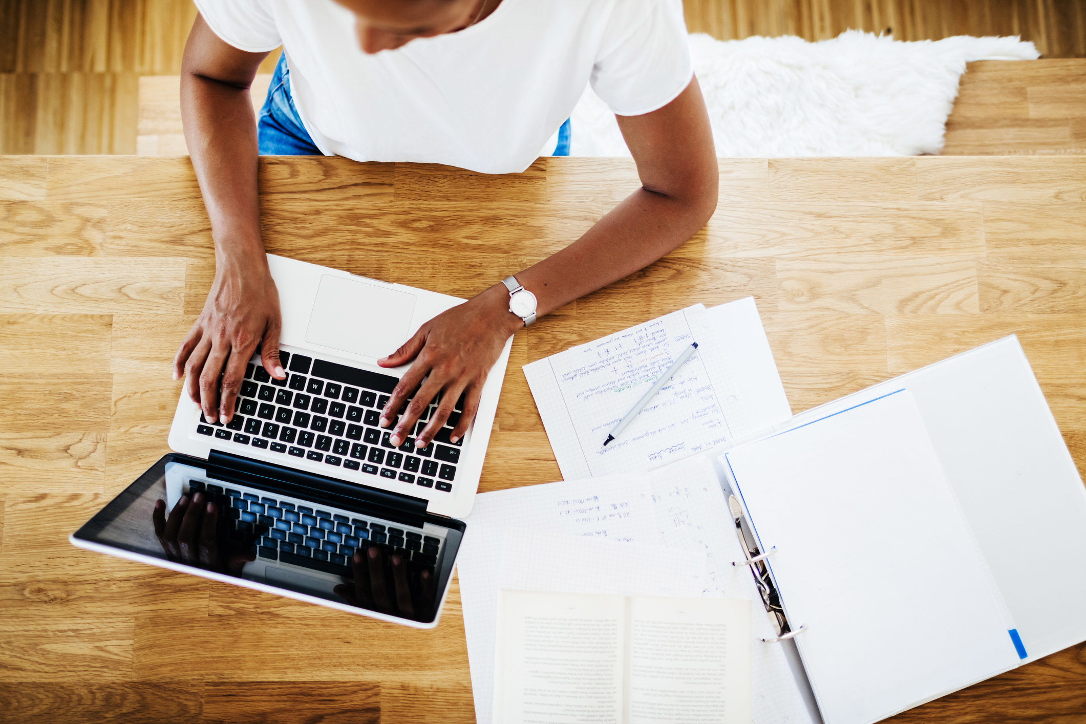 A model with a laptop and papers