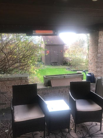 Reviewer's image of heater hanging from atop patio 