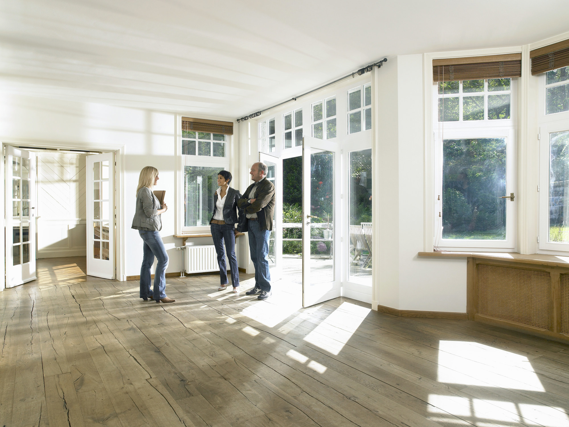 A real estate agent showing a home to a couple