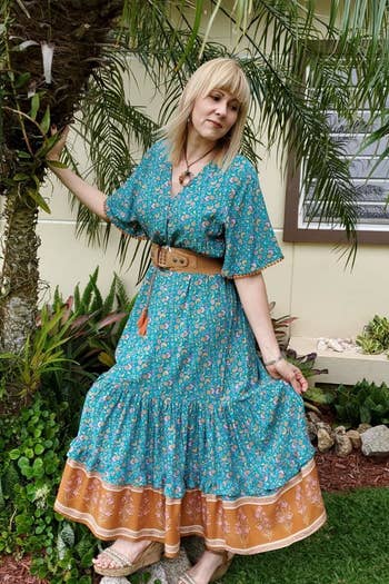 Reviewer wearing dress in the green pattern