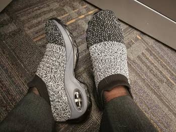 Reviewer wearing sock-sneakers in the shade gray