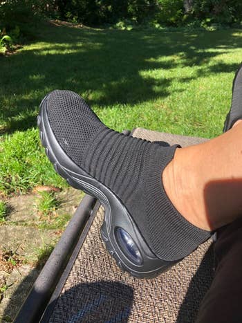 Reviewer wearing sock-sneakers in the shade pure black