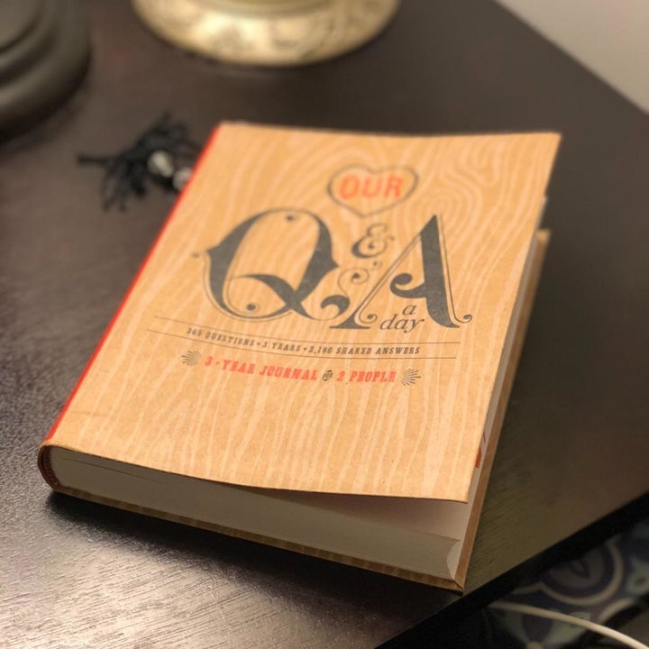 A journal sitting on a table that reads "Our Q&amp;A a Day" 