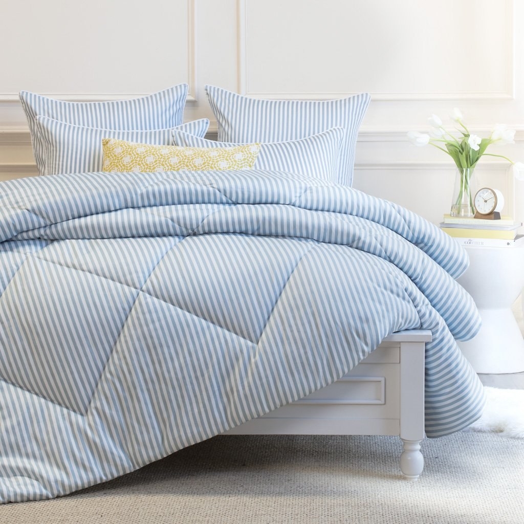 blue and white stripe comforter on bed