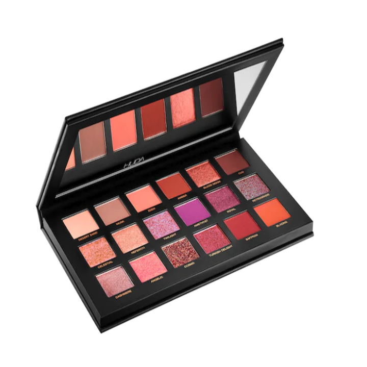A Huda eyeshadow palette of strong pinks and reds