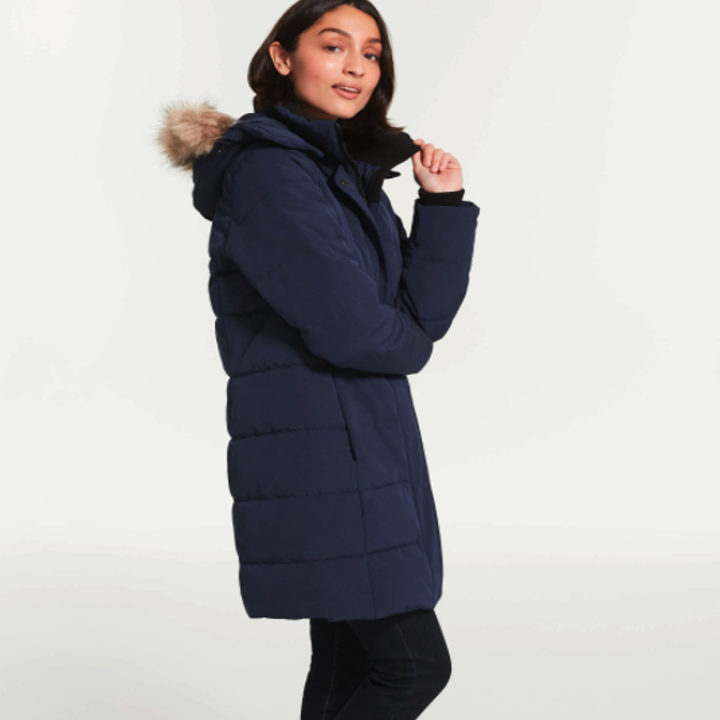 A model wearing a navy blue parka