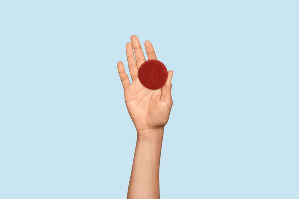 gif of a model&#x27;s hand  rotating with a Boie face scrubber on their finger