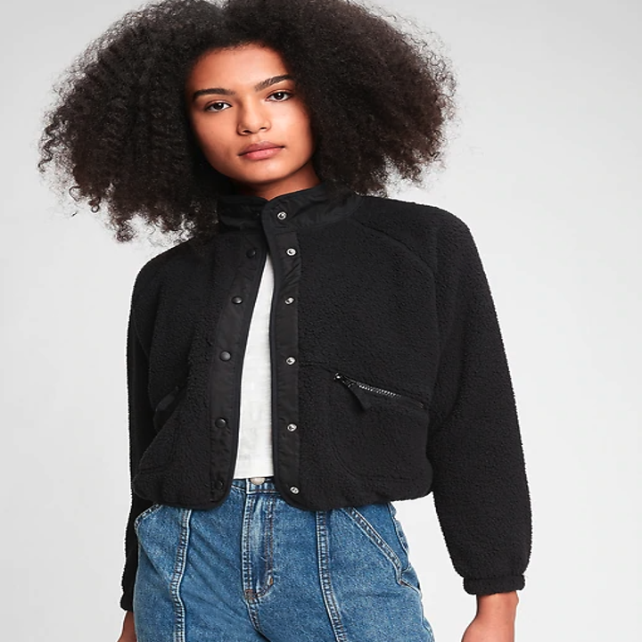 Model wearing a high-necked black bomber jacket