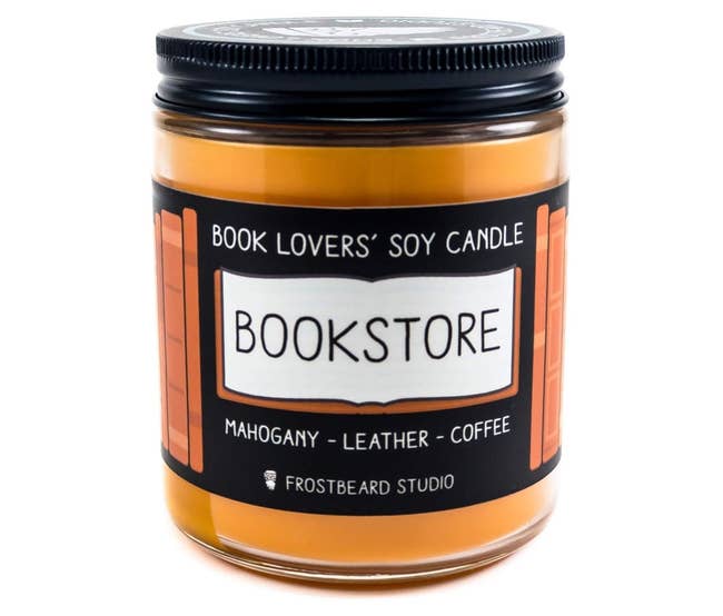 the orange candle with the bookstore label and labeled as smelling like mahogany, leather, and coffee