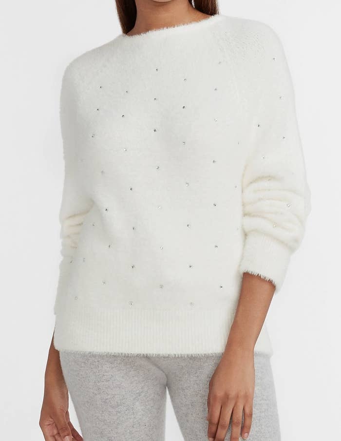 a cozy white fur embellished v-neck sweater