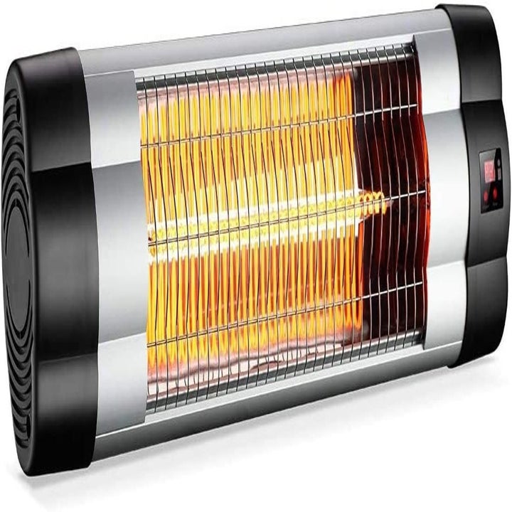 Metallic heater with black ends turned on with lit up orange coils