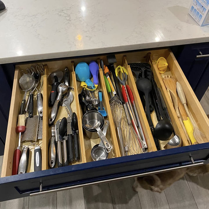 reviewer image of the dividers installed in drawer to organize utensils