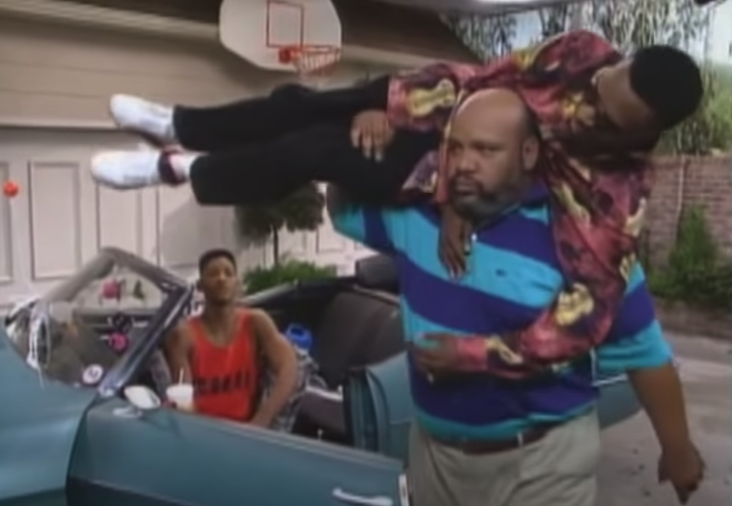 Uncle Phil carrying Jazz on his shoulder, ready to throw him inside the house
