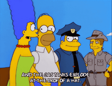 Marge Simpson gesturing while saying &quot;And the gas tanks explode at the drop of a hat&quot; to Homer Simpson, Chief Wiggum, and man dressed as a ranger