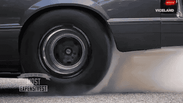 Car tire peeling out and smoking