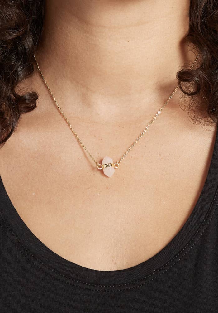 the short rose quartz necklace on a gold chain