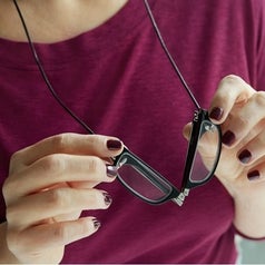 a person folding the glasses