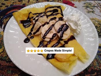 A reviewer's cooked crepes with chocolate sauce, bananas and whipped cream, and five stars and text 
