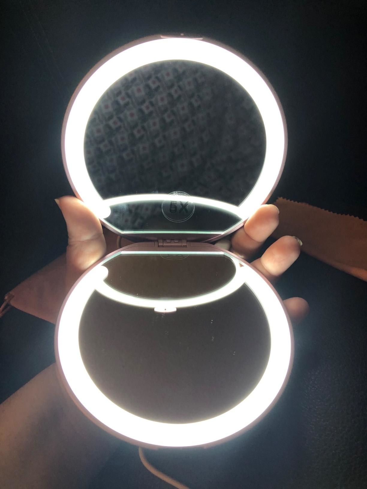 a reviewer showing the circular mirror lit up