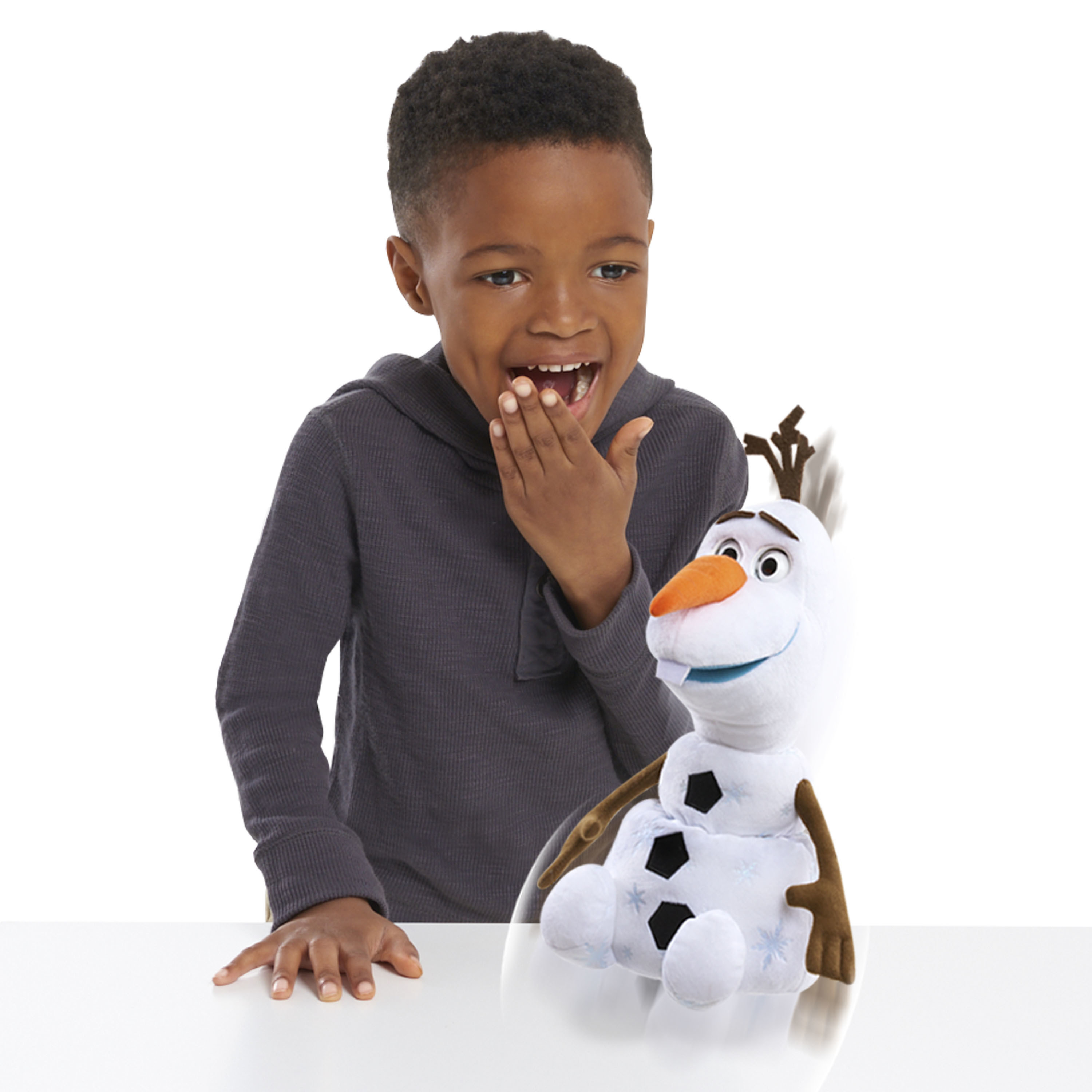 child laughing at an olaf toy that is moving around