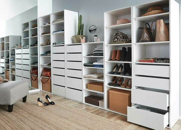 Large shelving unit showing off shoes, bags and hats with huge amounts of drawer space