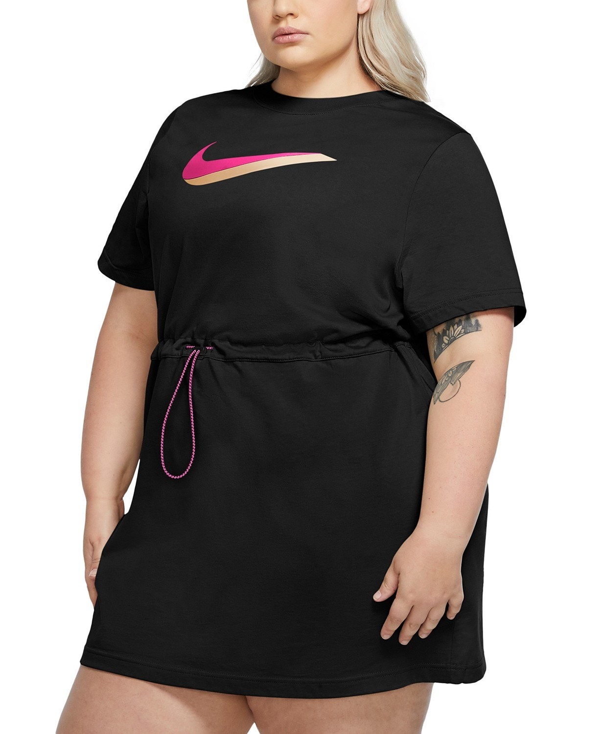Model wearing the black minidress with a pink nike swoosh on the chest