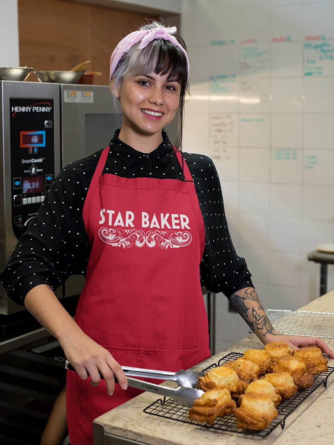 Model in the red apron with scrollwork and the words star baker at the top