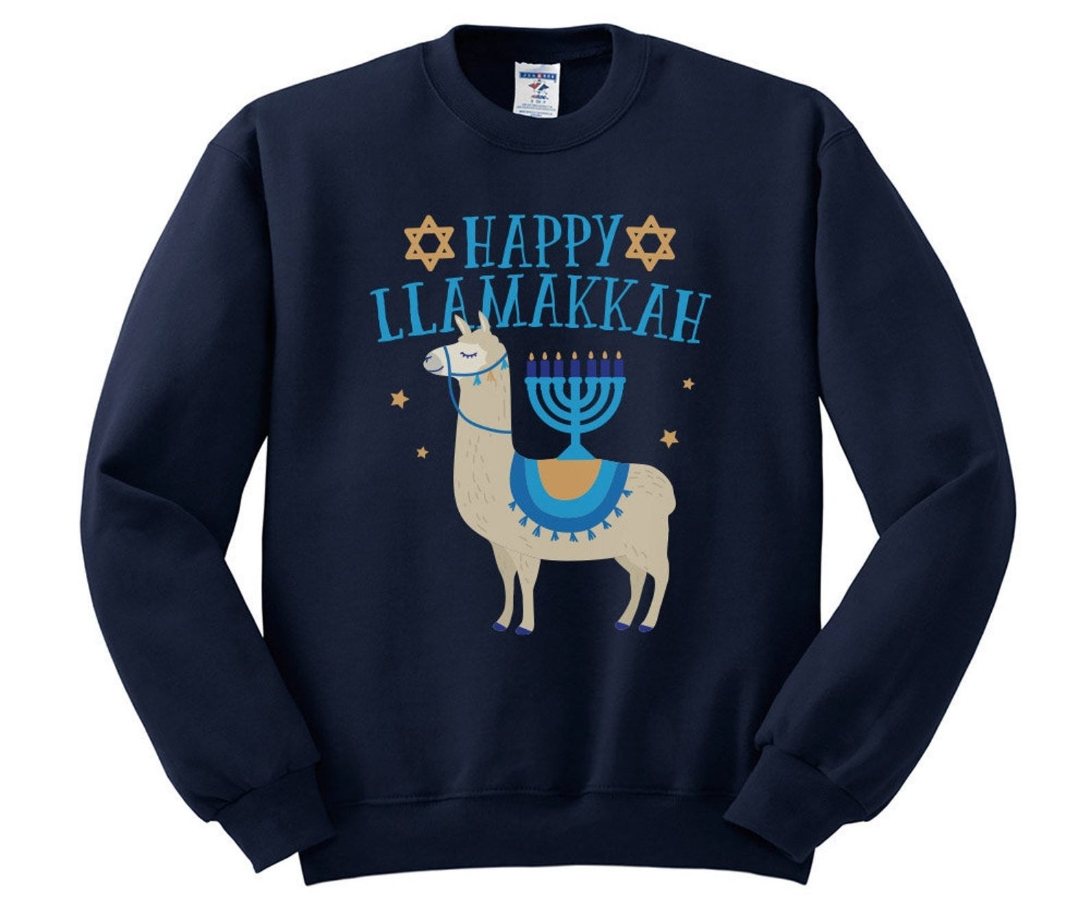 the blue pullover that reads &quot;happy llamakkah&quot; in blue text with an illustration of a llama with a menorah on its back