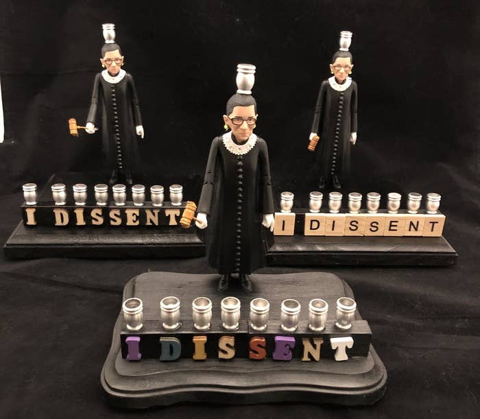 three of the different lettering options for the RBG menorah with a figurine of RBG as the shamash 