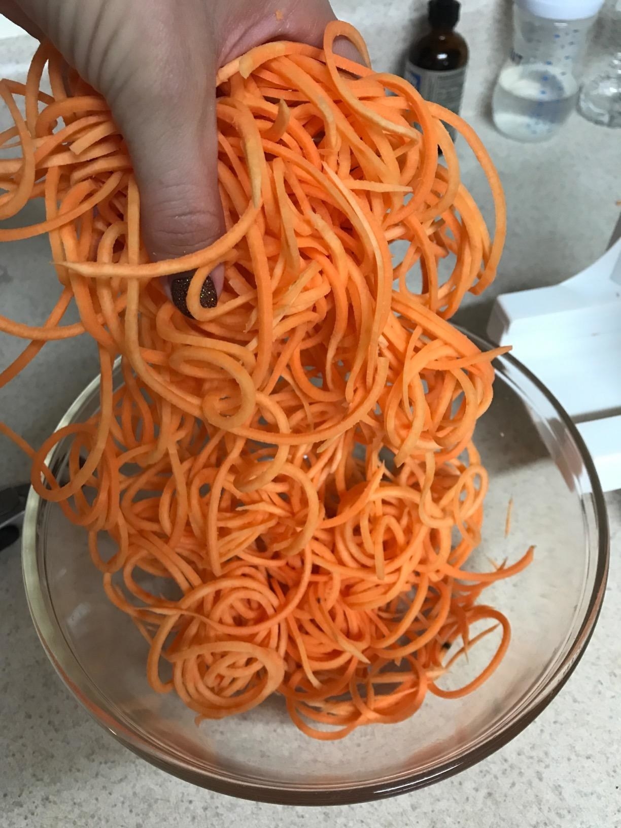 reviewer image of spiralized sweet potatoes and carrots in a bowl