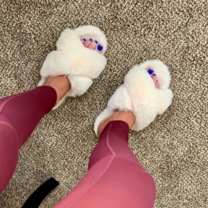 reviewer wearing the fuzzy slippers 