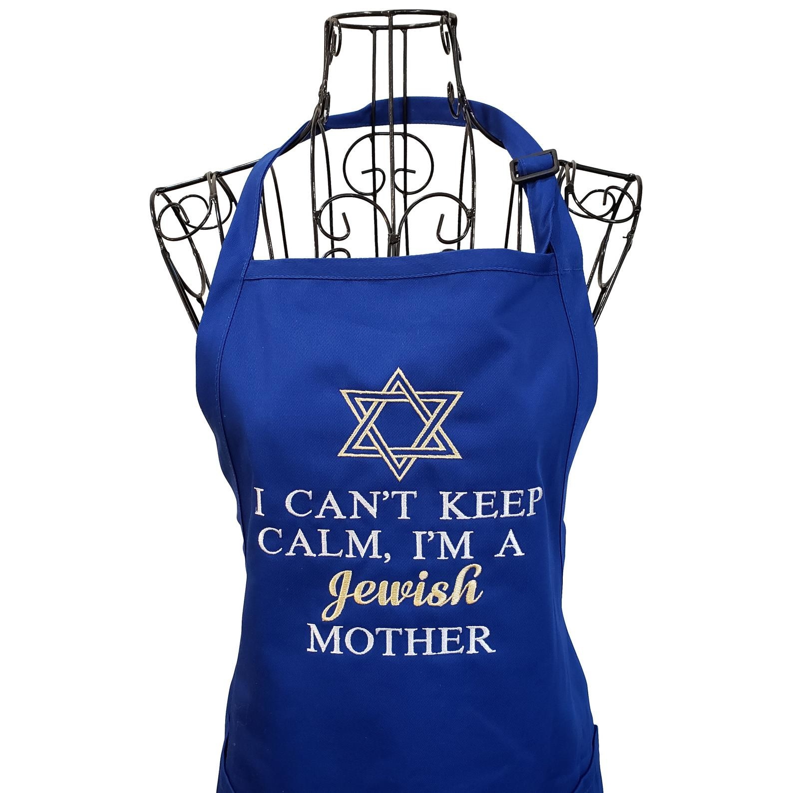 the blue apron with a star of david printed on it and white and gold text that reads &quot;I can&#x27;t keep calm, i&#x27;m a jewish mother&quot;