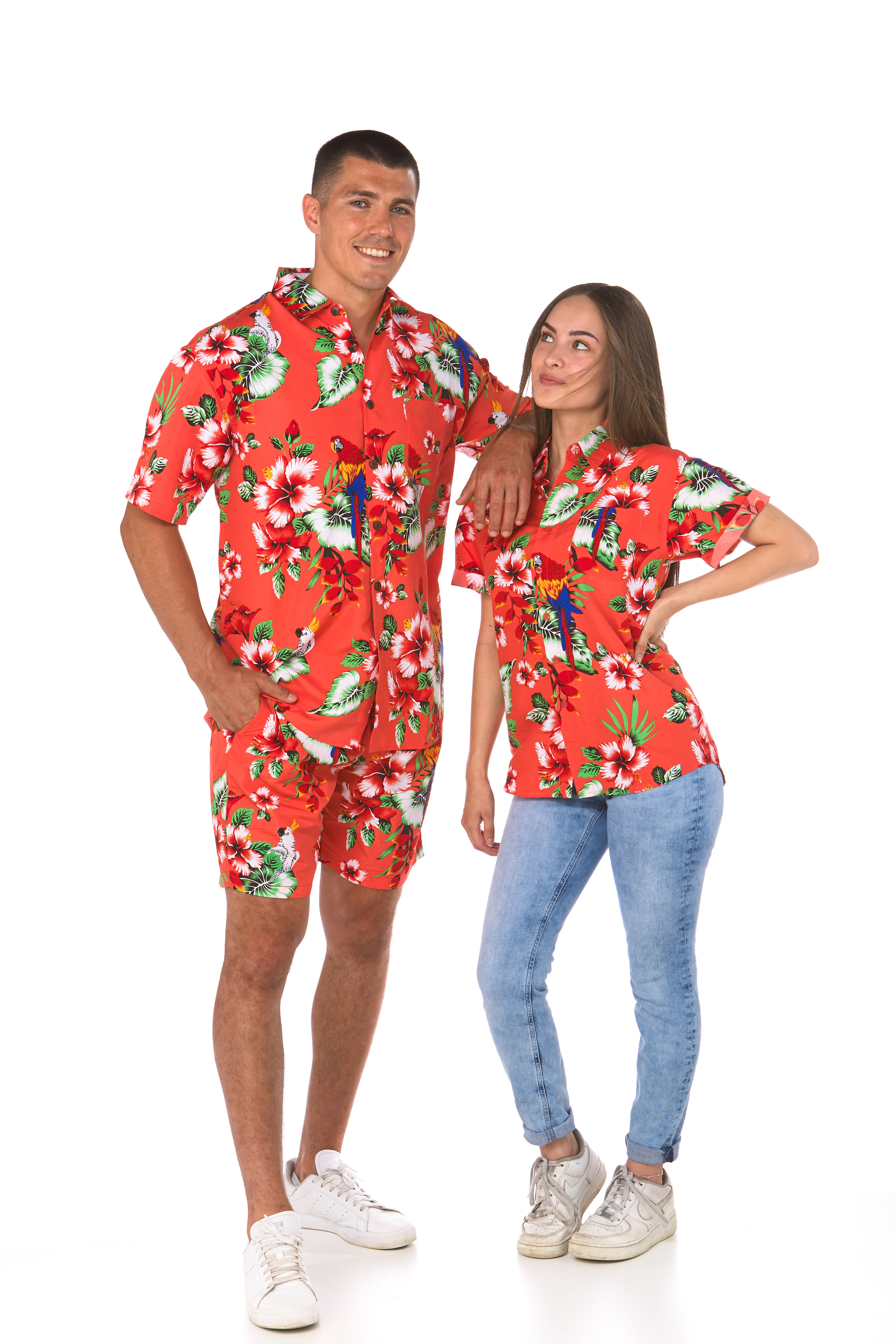 Man and woman pose in matching red Lowes&#x27; shirts with hibiscus flowers and parrots