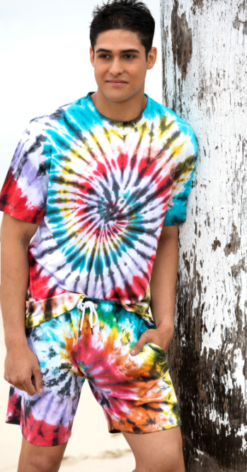 Man wearing a matching tie-dye shirt and shorts that are dyed in a spiralling pattern