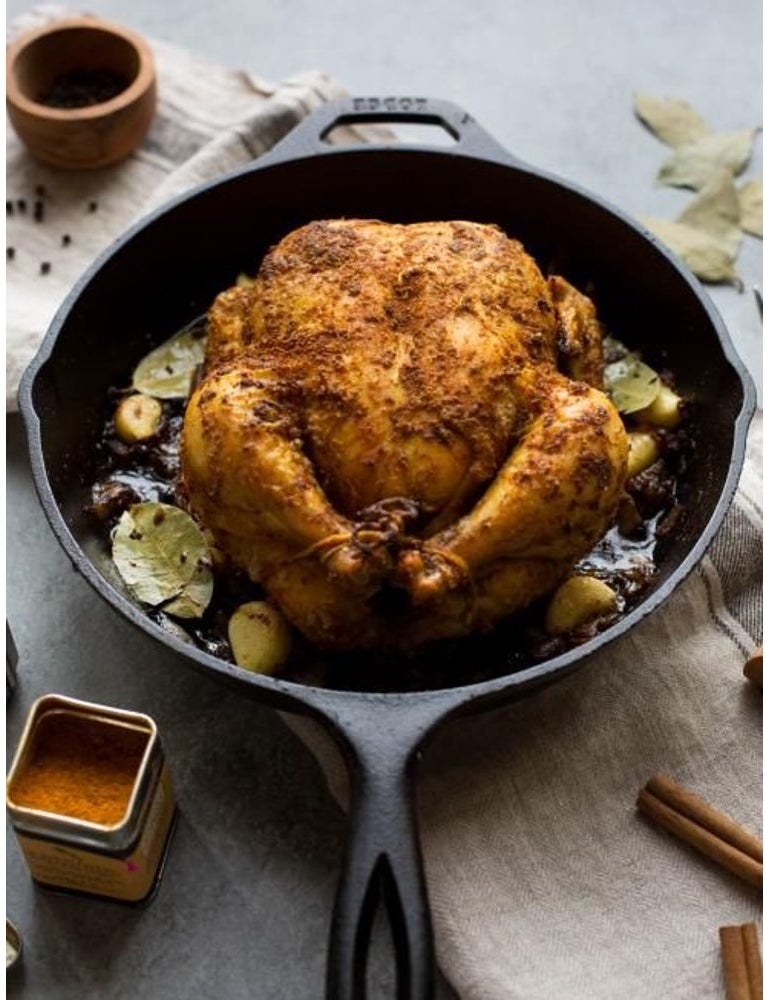 A roasted chicken in the cast iron skillet
