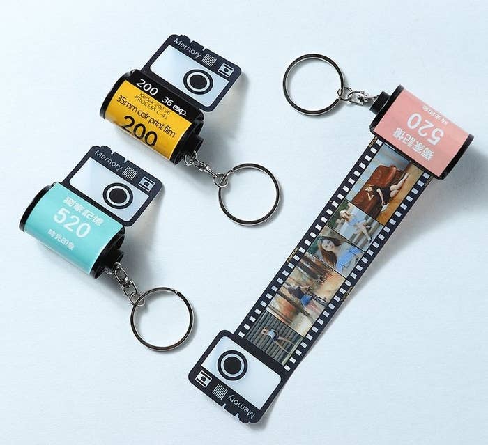 Tiny keychains with a film roll design. When you pull out the film, there is a strip of small customized photos
