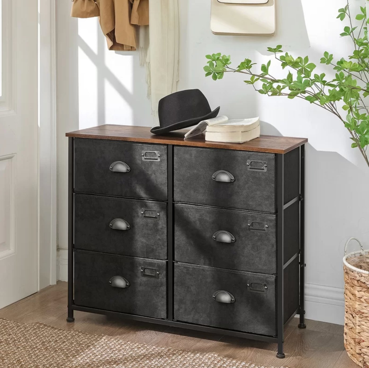 The six drawer dresser in black with a wood top