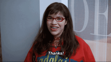 Gif of Betty in her iconic poncho from Ugly Betty