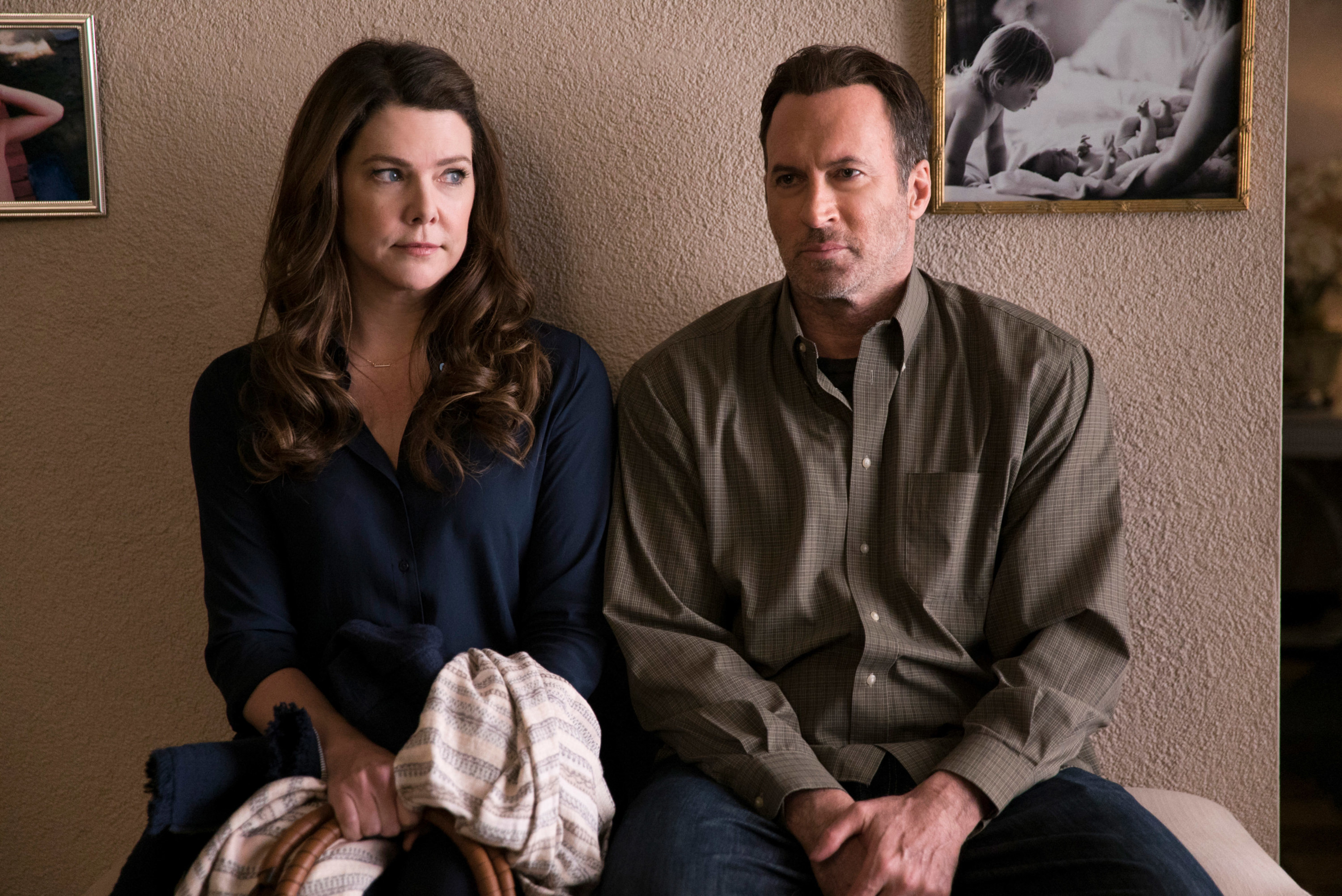 Lauren Graham and Scott Patterson sitting next to one another during a scene