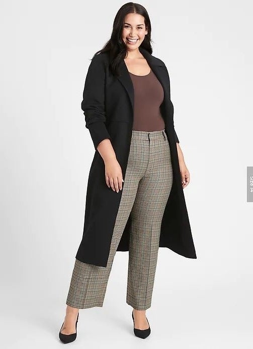 person wearing relaxed high waisted pants in a brown plaid design