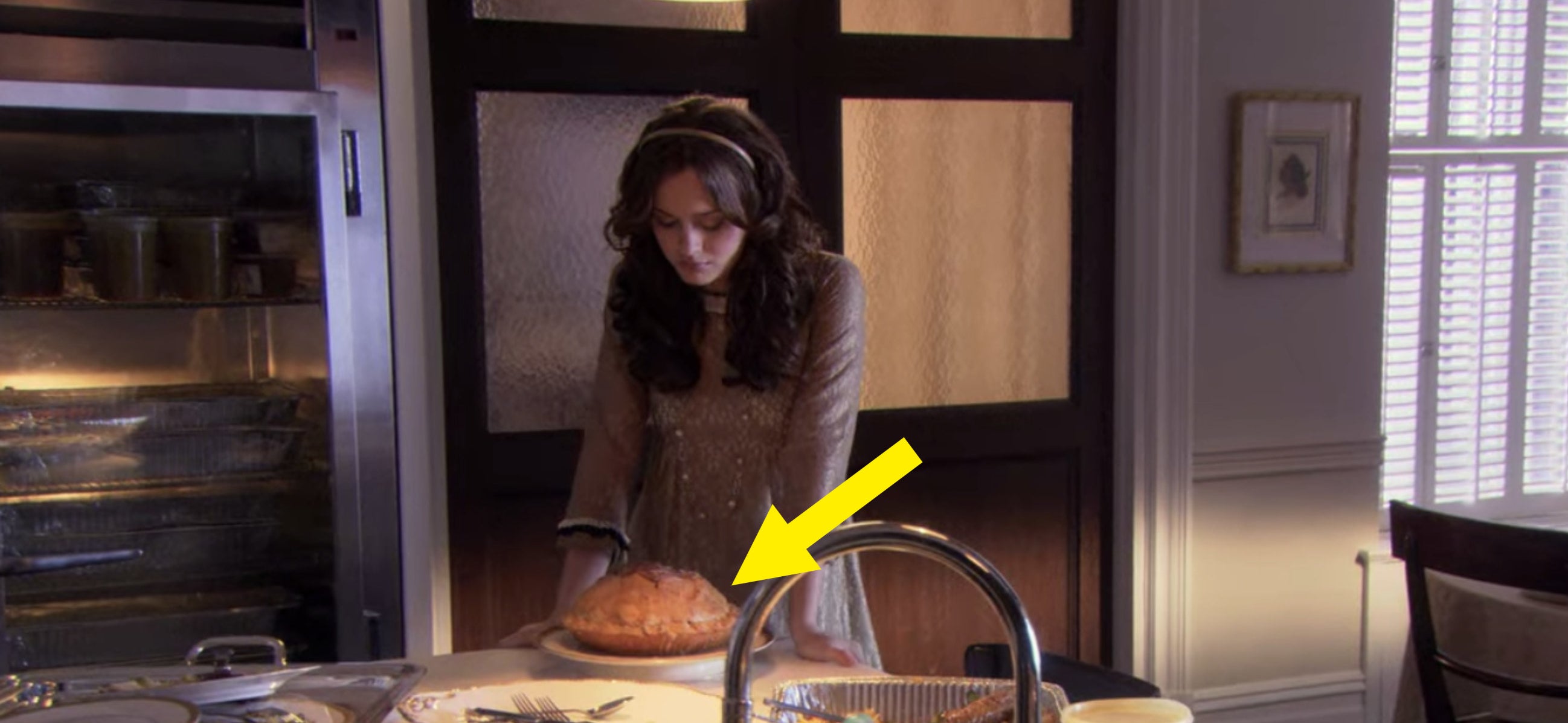 Blair looking down at an apple pie