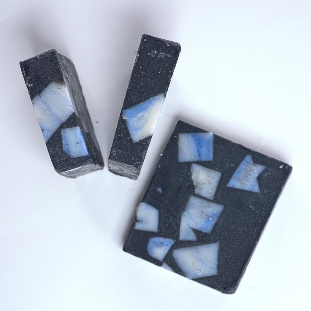 Black charcoal soap with blue marble soap in the middle