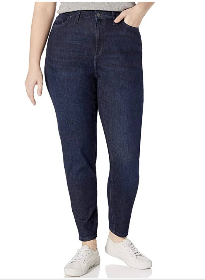 Model in a pair of high waisted, dark denim skinny jeans 