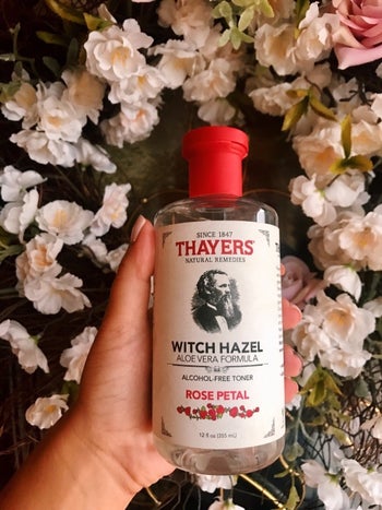 BuzzFeed Editor AnaMaria Glavan holds bottle of Thayer's Rose Petal Witch Hazel Facial Toner in their hand