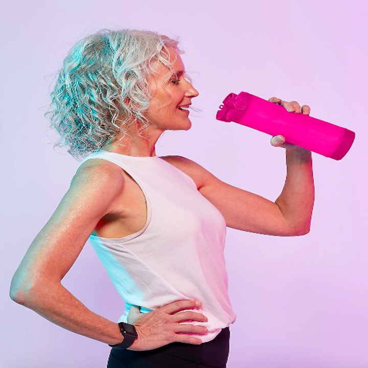 Person holding water bottle in pink 