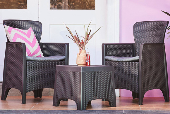 Two seater outdoor set styled with a ping zig-zag cushion and a small table 