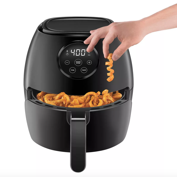 an airfryer filled with curly fries
