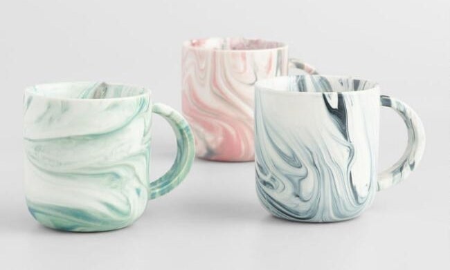 The set of marbled mugs which come in green, blue, and pink